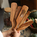 Wooden spatulas in hand