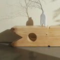 Close up of Peg-shaped side table with accessories