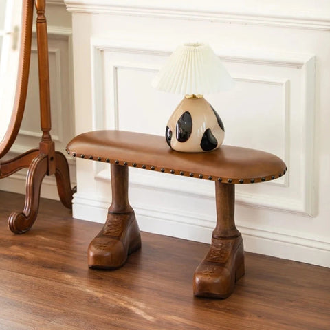 Bench with shoe-shaped fee living room with lamp on it