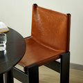 Wood and leather chair at table