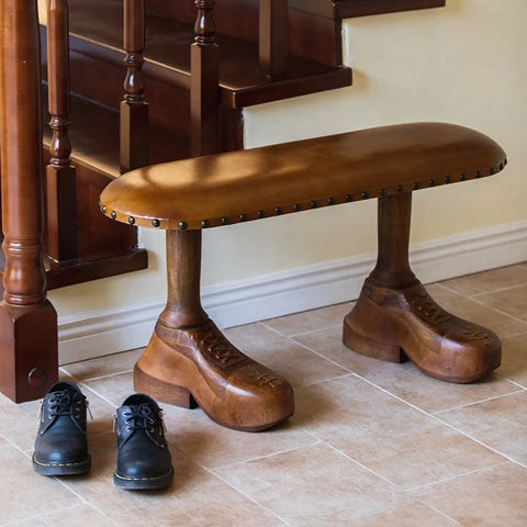 Bench with shoe-shaped feet in hallway