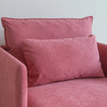 Close up of cushion on pink armchair