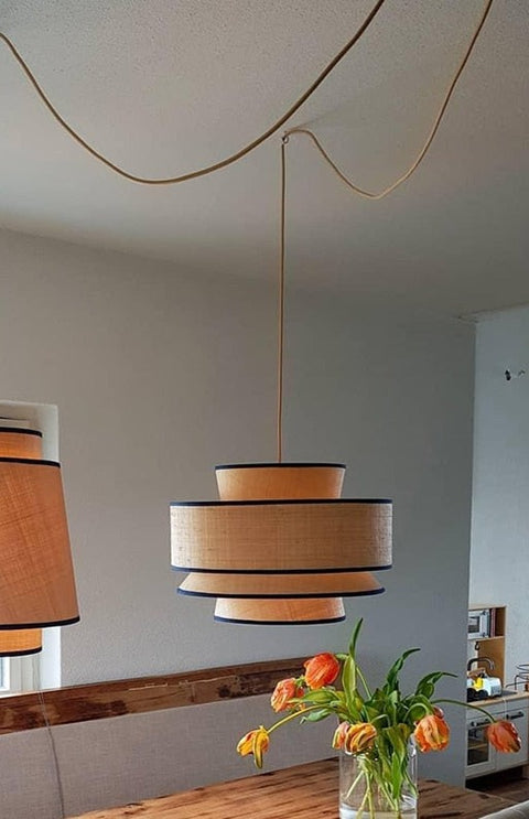 Pendant lamp above table.