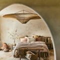 Rattan chandelier above bed