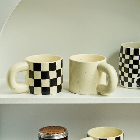 Checked and speckled mug on shelf