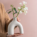 Person holding ceramic vase.