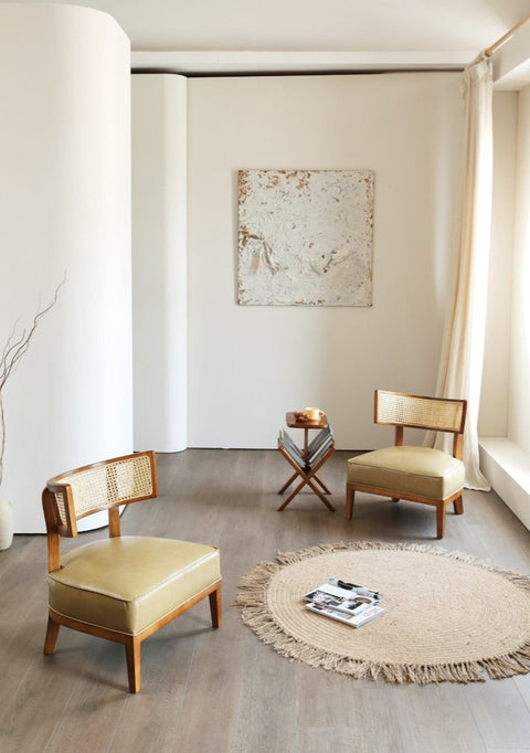 Matching set of wood and rattan, padded chairs and side table.