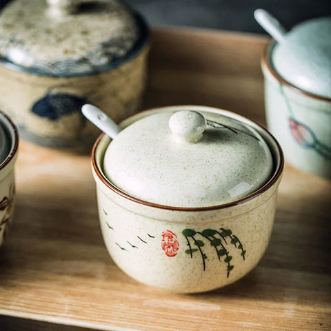 Spice dishes with lids and spoons on tray