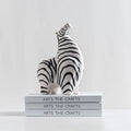 zebra ornament sat on stack of books