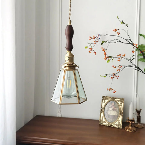 Stained glass pendant light hanging from ceiling above table