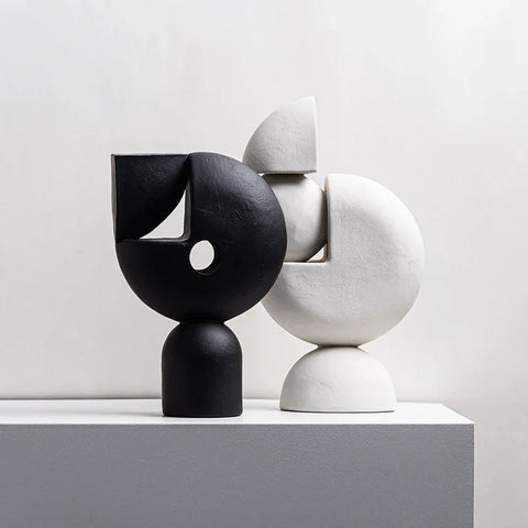 Black and white sculptures on tables