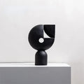 Black sculpture on table