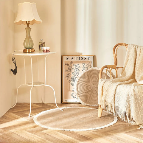 Woven round rugs with tassels.