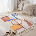 Geometric woven rug with tassels