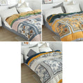 Three styles of patterned throw on bed.