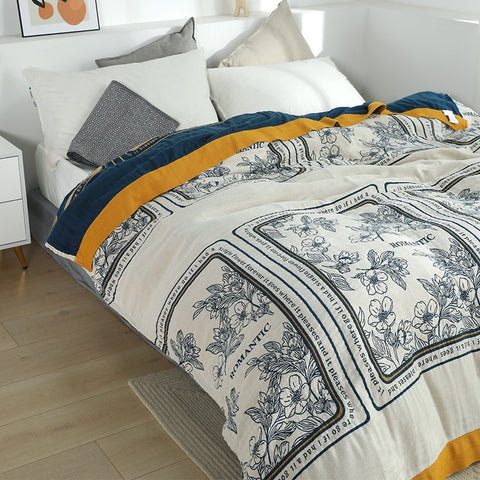 Patterned throw on bed.