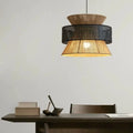 Black rattan atlas lamps hanging above table