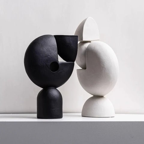 Black and white sculptures on tables