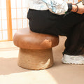 Person sitting on mushroom-shaped stool