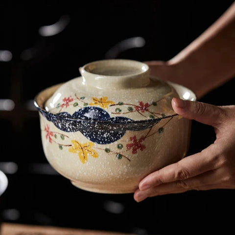 Ramen bowl with lid in someone's hands