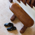 Bench with shoe-shaped feet in hallway