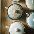 Sugar/spice dishes on table from above