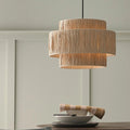 Lampshade in tiered design above table.