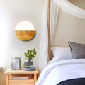 Circular Tuuli wall light in bedroom