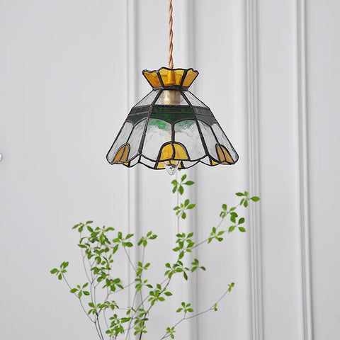 Stained glass pendant light hanging from ceiling