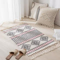 Geometric woven rug with tassels