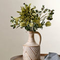 Vase on table with flowers