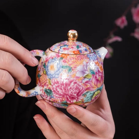 Someone holding the teapot