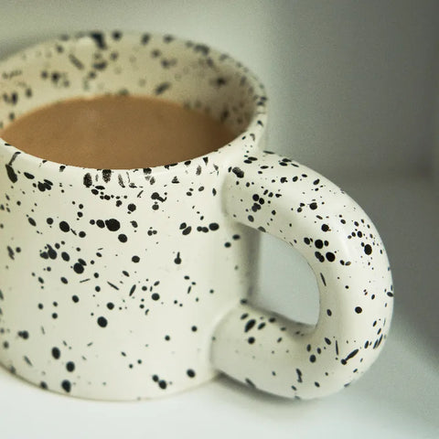 Close up of speckled mug with tea in it