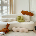 Selection of abstract-shaped pillows on sofa.