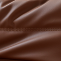 Close up of leather-look slouch couch chair.