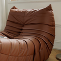 Close up of leather-look slouch couch chair.