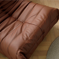 Close up of leather-look slouch couch chair.