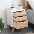 Wooden bedside table with drawers open.