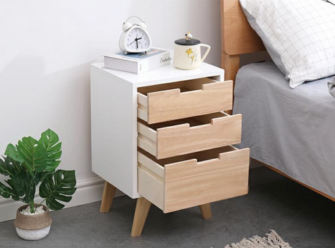 Wooden bedside table with drawers open.