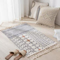 Geometric woven rug with tassels