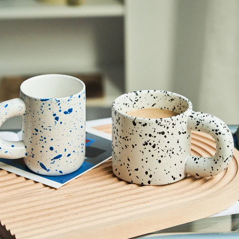 Speckled mugs on table