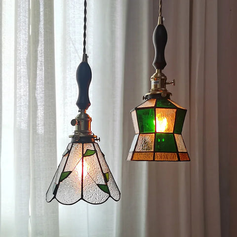 2 stained glass pendant light hanging from ceiling