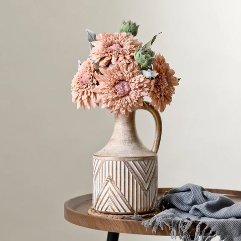 Vase on table with flowers