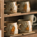 Mugs and coasters on shelf