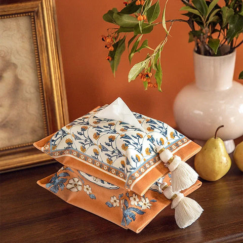 Two woven tissue boxes stacked on table