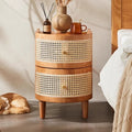 2 drawer side table with rattan look detailing in bedroom with items on top