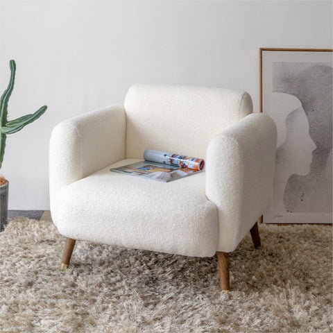 Padded chair in living room with magazine.