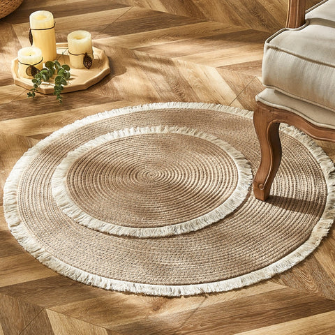 Two woven round rugs with tassels.